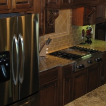 Kitchen stove and stainless steel refrigerator